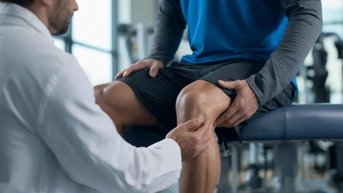 Orthopedic provider examining a patient’s knee